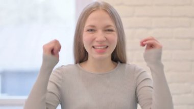 Portrait of Creative Young Woman Celebrating Success