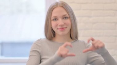 Loving Woman showing Heart Shape by Hands