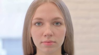 Close Up of Serious Creative Young Woman