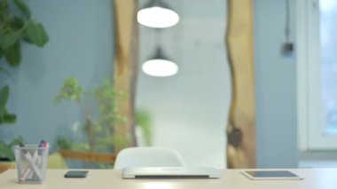 Young Woman Coming to Work, Typing on Laptop