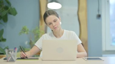 Female Graphic Designer Working on Laptop and Graphic Tablet