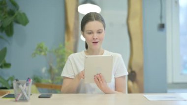 Excited Young Woman Cheering Win on Digital Tablet