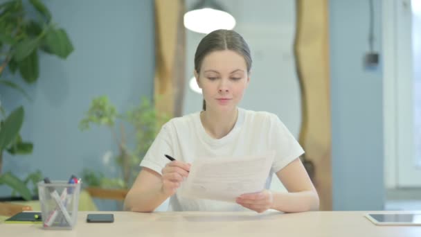 Young Woman Celebrating While Reading Documents Work — Stockvideo