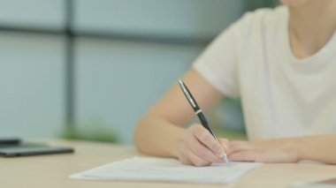 Close Up of Woman Writing at Work