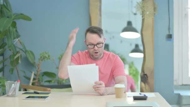Creative Adult Man Reading Documents Office Paperwork — Stockvideo