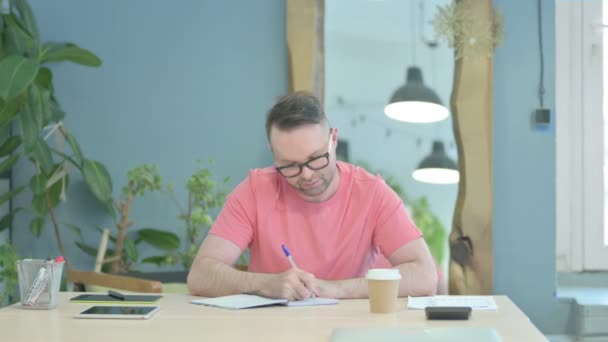 Creative Man Writing While Sitting Office — Stockvideo