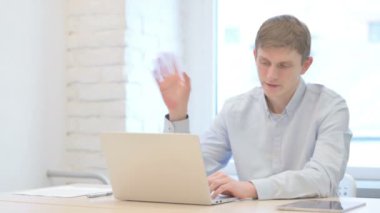 Young Businessman Doing Video Chat on Laptop