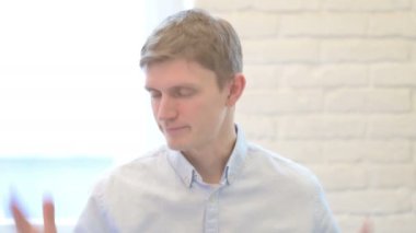 Upset Young Businessman Reacting to Loss