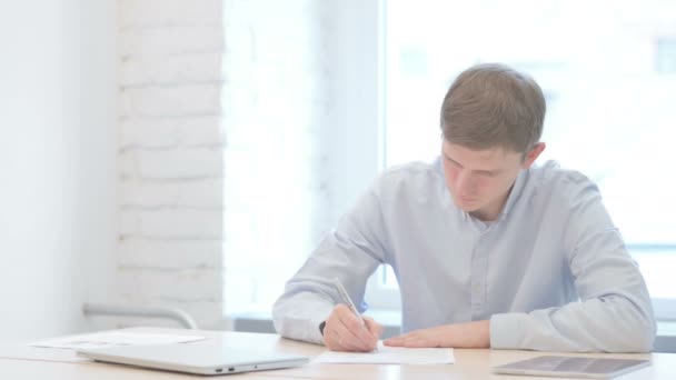 Jonge Zakenman Schrijven Tijdens Het Zitten Office — Stockvideo