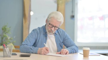 Senior Old Man Doing Calculation Work on Documents