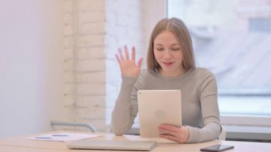 Creative Young Woman Talking for Online Video Chat via Tablet Computer