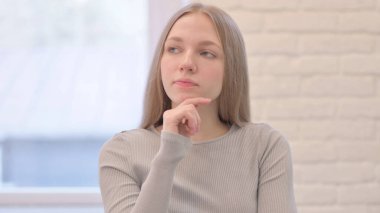 Portrait of Creative Young Woman Thinking an Idea