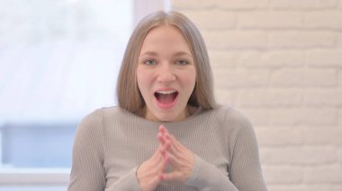 Amazed Woman Claaping in Excitement of Success