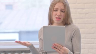 Creative Young Woman Shocked by Loss on Digital Tablet