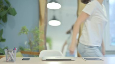 Young Woman Leaving Office after Work