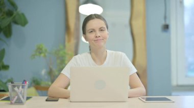 Young Woman Shaking Head in Denial at Work