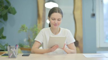 Young Woman Using Tablet for Browsing Internet
