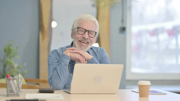 Confident Senior Old Man Looking Camera While Using Laptop — Photo