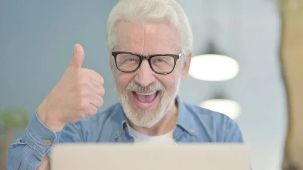 Close Up of Thumbs Up by Senior Old Man Working on Laptop