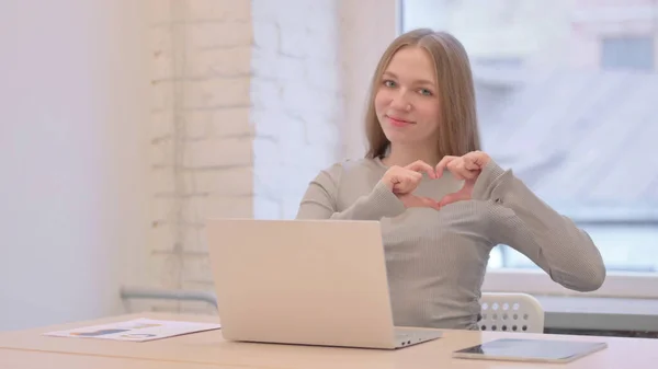 Creative Young Woman Showing Heart Sign While Using Laptop — 图库照片