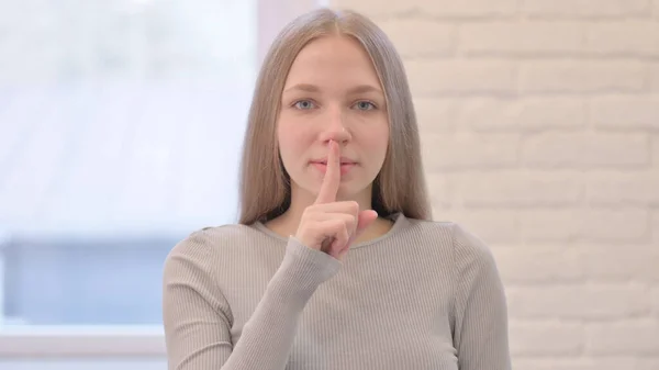 Young Woman Asking for Silence With Fingers on Lips, Quiet Please