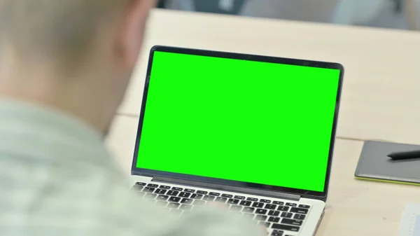 Man Working on Laptop with Chroma Key Green Screen