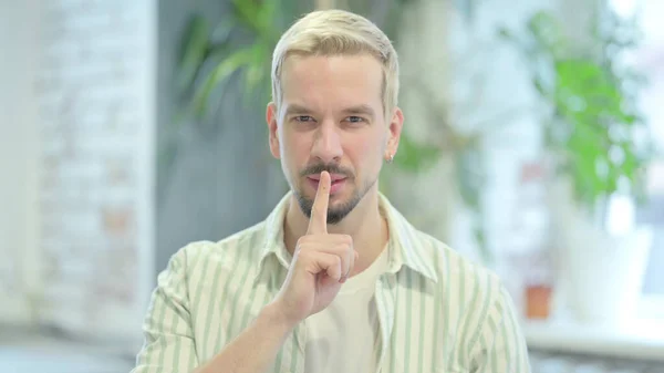 Modern Young Man Asking for Silence, Finger on Lips