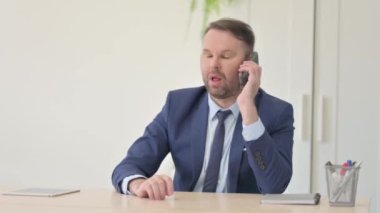 smartphone üzerinde konuşan işadamı