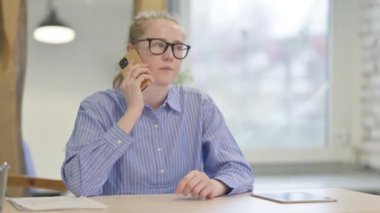 Telefonda konuşan kızgın genç kadın.