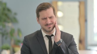 Portrait of Young Businessman with Toothache