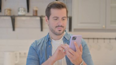 Akıllı telefon kullanan genç adamın portresi