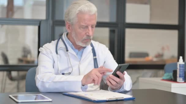 Senior Doctor Browsing Smartphone Clinic — Stock Video