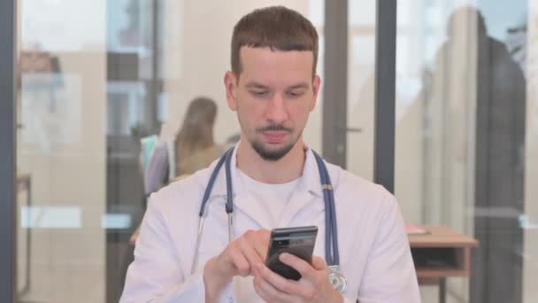 Middle Aged Doctor Browsing Internet Phone — Stock Video