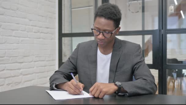 Young African Man Writing Letter Office — Stock Video