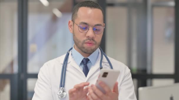 Portrait Mixed Race Doctor Using Phone — Stok Video