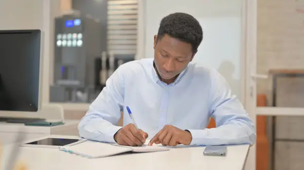 stock image African Businessman Writing a Letter in Office