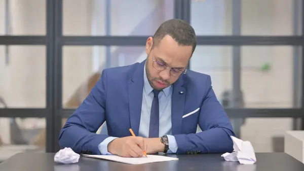 Mixed Race Businessman Struggling to Write a Letter
