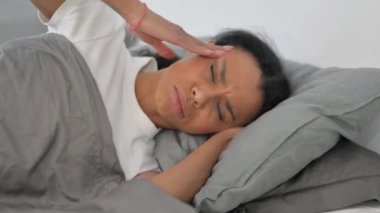 Yatakta yatarken baş ağrısı çeken Afrikalı Kadın