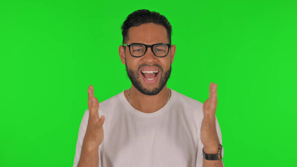 Frustrated Man Screaming Loud on Green Background