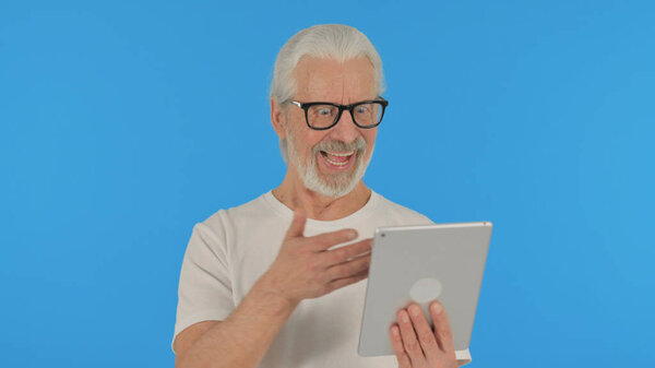Casual Old Man Celebrating Success on Tablet on Green Background
