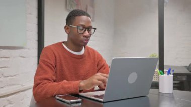 African American Man with Neck Pain Working on Laptop