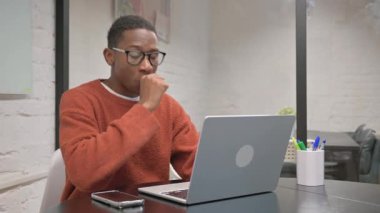 Coughing African American Man Working on Laptop