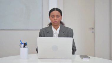 Laptop with Green Screen on Desk in Office
