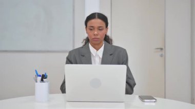 Laptop with Green Screen on Desk in Office