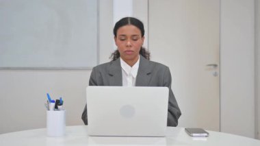 Laptop with Green Screen on Desk in Office