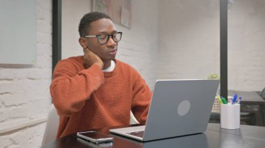 African American Man with Neck Pain Working on Laptop