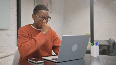 Coughing African American Man Working on Laptop