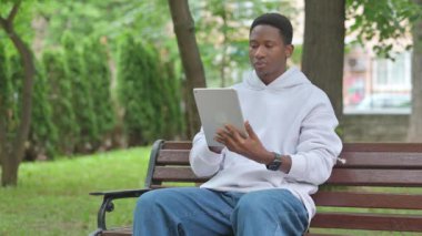 Genç Afrikalı Adam Bench 'te Dijital Tablet Kullanıyor