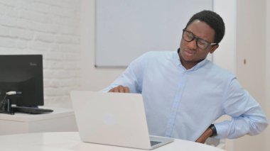 Young African Businessman with Back Pain at Work