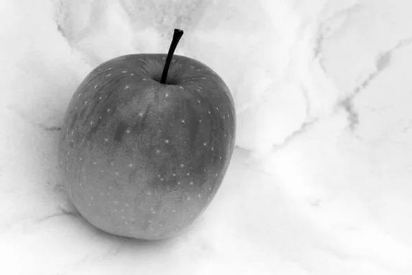 Black and white apple on marble background